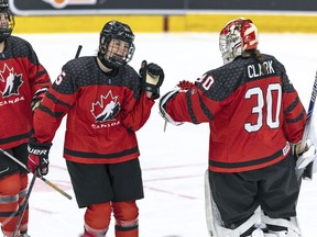 Canada's Gracie Graham, centre, reacts with goalkeeper Hannah Clark, right, during the Women's U18 Ice Hockey World Championship match between Canada and Sweden, in Ostersund, Sweden, Sunday, Jan. 15, 2023. Graham had a goal and two assists as Canada advanced to the semifinals of the world women's under-18 hockey championship with a 6-0 win over host Switzerland on Thursday.