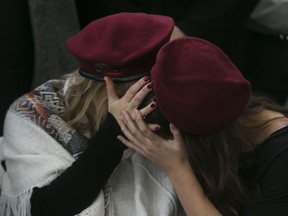 Family members mourn during a funeral