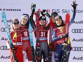 Austria's Stephanie Venier, second from left, winner of an alpine ski, women's World Cup downhill race, celebrates on the podium with second-placed Switzerland's Lara Gut Behrami, left, and Canada's Valerie Grenier, third from right, Austria's Christina Ager, second from right, and Italy's Sofia Goggia, right, who tied for third place, in Cortina d'Ampezzo, Italy, Friday, Jan. 26, 2024.