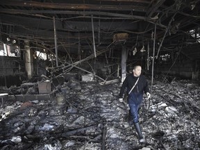 A shop owner comes to see his burnt-out restaurant