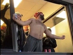 Jason Kelce celebrates without a shirt, and with a beer in hand, after watching his brother, Travis, score a touchdown for the Chiefs.