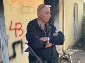 Ilan Cohen, a resident of Kibbutz Re’im and part of the community’s security response team, stands outside of a destroyed home. Cohen helped fight back against the Oct. 7 Hamas attack for days until the Israeli army could remove the terrorists. (Brian Lilley, Toronto Sun)