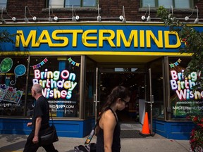 Mastermind has terminated about 270 employees as the toy retailer is turned over to new ownership. Pedestrians walk past a Mastermind Toys store on Queen St. East in Toronto, Tuesday, Sept. 19, 2017.