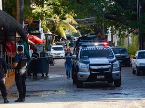 In this file photo taken on Jan. 16, 2017, Mexican police agents patrol near a nightclub in Playa del Carmen, Quintana Ro state.