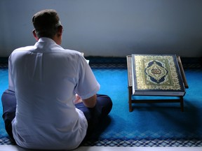 A Muslim recites the Koran inside a mosque
