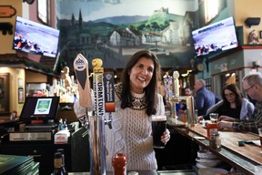 Republican presidential candidate, former UN ambassador Nikki Haley, enjoys a beer while visiting the Holy Grail Restaurant and Pub on Jan. 21, 2024, in Epping, N.H.