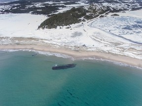 The massive, overturned hull of a seemingly ancient ship has appeared without warning along Newfoundland's southwestern tip as shown in this handout image provided by Corey Purchase.