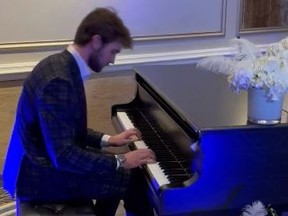 Maple Leafs goaltender Joseph Woll plays the piano during a gala fundraiser event on Monday night.
