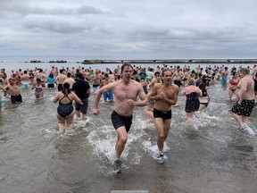 More than 300 people welcomed the new year by taking a frigid dip at Sunnyside Beach on Monday.