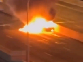 A Mercedes is engulfed in flames on the Gardiner Expressway on Jan. 18, 2024 in a screengrab from video posted to X.