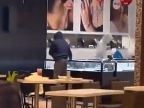 A posting on social media by @therealhebrahim shows three suspects smashing display cases at a jewelry store in Richmond Hill.