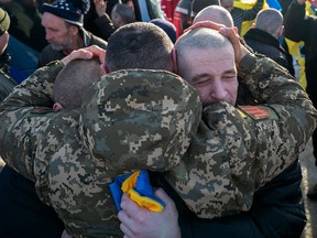 Ukrainian former prisoners of war reacting following a prisoner exchange