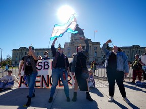 People attend a rally opposing the Saskatchewan government's proposed legislation on its pronoun policy in front of the Saskatchewan Legislative Building in Regina, Tuesday, Oct. 10, 2023.