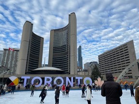 People ice skating at Nathan Phillips Square.