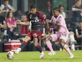 Toronto FC forward Lorenzo Insigne (24) passes past Inter Miami defender DeAndre Yedlin during the first half of an MLS soccer match, Wednesday, Sept. 20, 2023, in Fort Lauderdale, Fla.