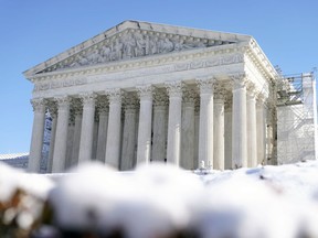 The U.S. Supreme Court is photographed through snow on Wednesday, Jan. 17, 2024, in Washington.