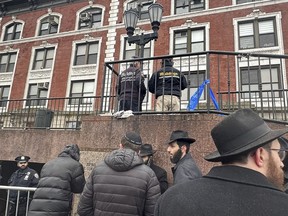 City inspectors and police officers outside the Brooklyn borough, N.Y., headquarters of the Chabad movement, Tuesday, Jan. 9, 2024. The building was evacuated after a tunnel was discovered Monday evening.