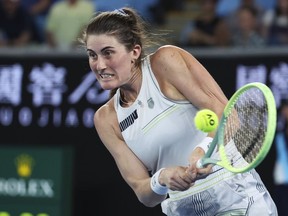 Rebecca Marino of Canada plays a backhand return to Jessica Pegula of the U.S. during their first round match at the Australian Open tennis championships at Melbourne Park, Melbourne, Australia, Tuesday, Jan. 16, 2024.