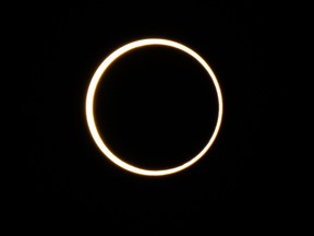The moon descends over the sun's horizon during an annular solar eclipse on Oct. 14, 2023 in Kerrville, Texas.