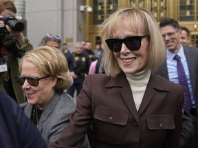 FILE - E. Jean Carroll, right, walks out of Manhattan federal court, May 9, 2023, in New York. The notorious 2005 "Access Hollywood" video in which Donald Trump was caught on a hot mic speaking disparagingly about women over a decade before he became president can be shown to jurors deciding what he owes Carroll, a columnist he defamed, a federal judge ruled Tuesday, Jan. 9, 2024, as he set up ground rules for a trial next week.