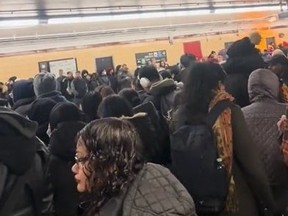 Crowd of people waiting at TTC station.