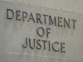 An exterior sign is photographed outside the Robert F. Kennedy Department of Justice building in Washington on May 4, 2021.