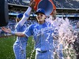 Kansas City Royals' Bobby Witt Jr. gets a cooler of water dumped on him.