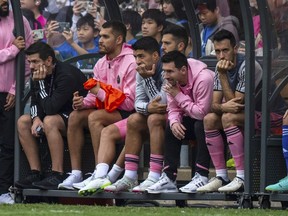 Inter Miami's Lionel Messi, sixth from left, looks on from the bench during the friendly football match between Hong Kong Team and US Inter Miami CF.