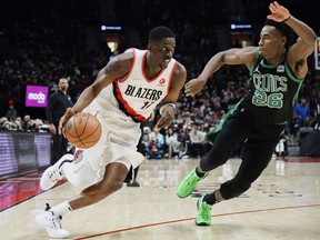 Portland Trail Blazers forward Tony Snell (17) drives to the basket against Boston Celtics forward Aaron Nesmith during at game in 2021.