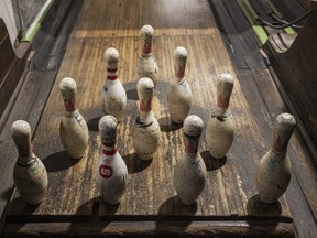 Bowling pins are lined up at an alley.