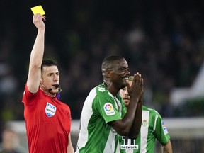 Betis' William Carvalho receives a yellow card during a match in 2023.