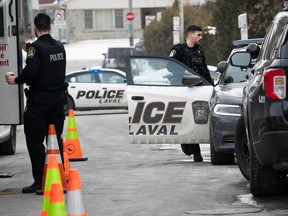 Laval police outside an apartment where two bodies were discovered on Wednesday, Feb. 7, 2024.