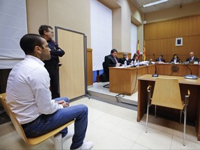 Brazilian soccer star Dani Alves sits during his trial in Barcelona.