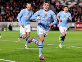 Phil Foden of Manchester City celebrates scoring his team's second goal against Brentford FC.