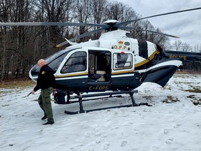 Members of the Ontario Provincial Police Aviation Services, from general headquarters in Orillia, prepare their helicopter at Charleston Lake Provincial Park Monday, Feb. 12, 2024 after two people hiking Sunday went missing. Their bodies were found around 4 p.m. (KEITH DEMPSEY/Local Journalism Initiative RepMembers of the Ontario Provincial Police Aviation Services, from general headquarters in Orillia, prepare their helicopter at Charleston Lake Provincial Park Monday, Feb. 12, 2024 after two people hiking Sunday went missing. Their bodies were found around 4 p.m. (KEITH DEMPSEY/Local Journalism Initiative Reporter)orter)