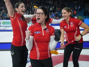 Team Canada skip Kerri Einarson, front, second Shannon Birchard, back left, third Val Sweeting, hidden back centre, and lead Briane Harris, right, celebrate after winning the Scotties Tournament of Hearts in 2023.