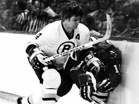 Bobby Orr of the Boston Bruins checks Dennis Hull of the Chicago Blackhawks.