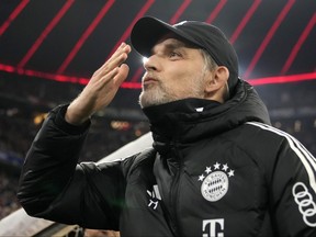 Bayern's head coach Thomas Tuchel greets fans.