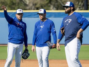 Toronto Blue Jays pitchers José Berríos (left), Yariel Rodriguez and Alek Manoah (right) participate in drills during Spring Training.