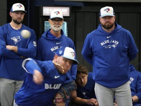 Toronto Blue Jays manager John Schneider, right, watches pitcher Yariel Rodriguez throw during a baseball spring training workout.