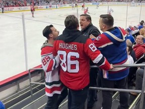 Supporters of the New Jersey Devils and New York Rangers clash in the stands.