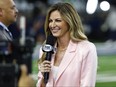 Fox Sports reporter Erin Andrews stands on the sideline before an NFL football game.