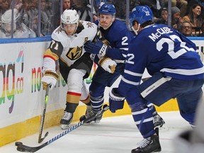William Karlsson of the Vegas Golden Knights battles for the puck against Simon Benoit of the Toronto Maple Leafs.