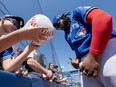 Toronto Blue Jays' Vladimir Guerrero Jr. signs autographs prior to Spring Training action against the Pittsburgh Pirates.
