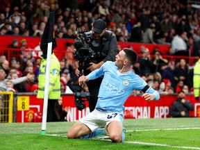 Phil Foden of Manchester City celebrates after scoring the team's third goal during the Premier League match against Manchester United.