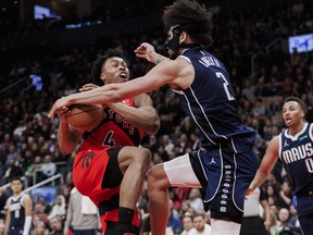 Scottie Barnes of the Toronto Raptors steps to the net against Dereck Lively II of the Dallas Mavericks.