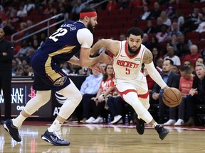 Fred VanVleet of the Houston Rockets dries around Larry Nance Jr. of the New Orleans Pelicans.