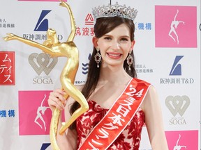 This photo taken on January 22, 2024 shows Karolina Shiino, a model who became a naturalized Japanese citizen from Ukraine, posing with the trophy of the Miss Japan crown in Tokyo. (Photo by STR/JIJI Press/AFP via Getty Images)