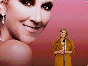 Celine Dion gets a standing ovation as she presents the Album Of The Year award on stage during the 66th Annual Grammy Awards.