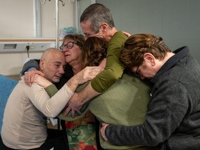 This handout picture released by the Israeli army on February 12, 2024, shows rescued Israeli-Argentinian hostage Louis Har (L) being reunited with his family at the Tel Hashomer Hospital in Ramat Gan, on the outskirts of Tel Aviv. (Photo by Israeli Army/AFP via Getty Images)